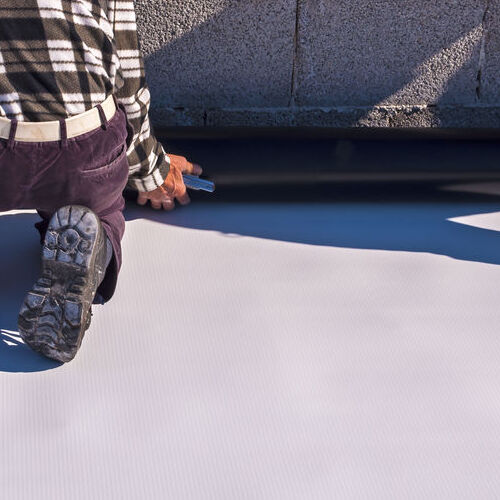Worker on application Synthetic waterproofing PVC-P and TPO / FPO